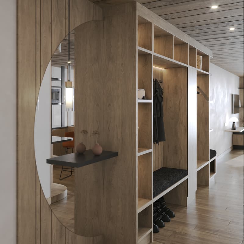 Spacious walk-in closet with wooden built-in shelves, mirror, hanging coat rack, black shoes, and decorative objects on top shelf.