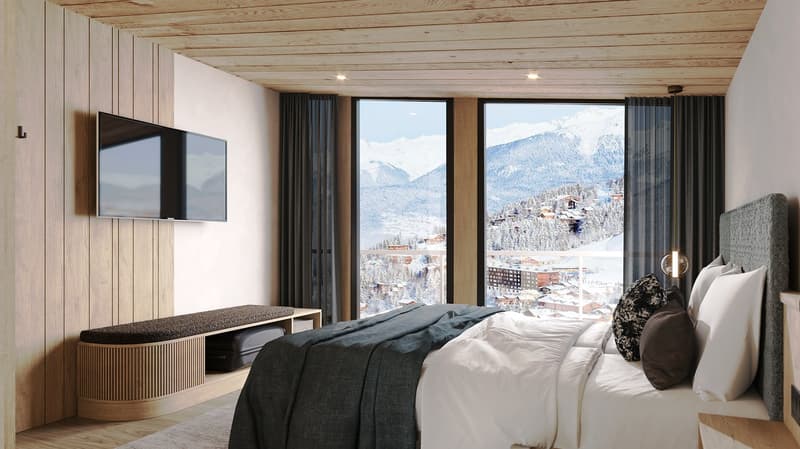 wooden walls, large windows, flat-screen TV, bed with grey blanket, bedside table, rug