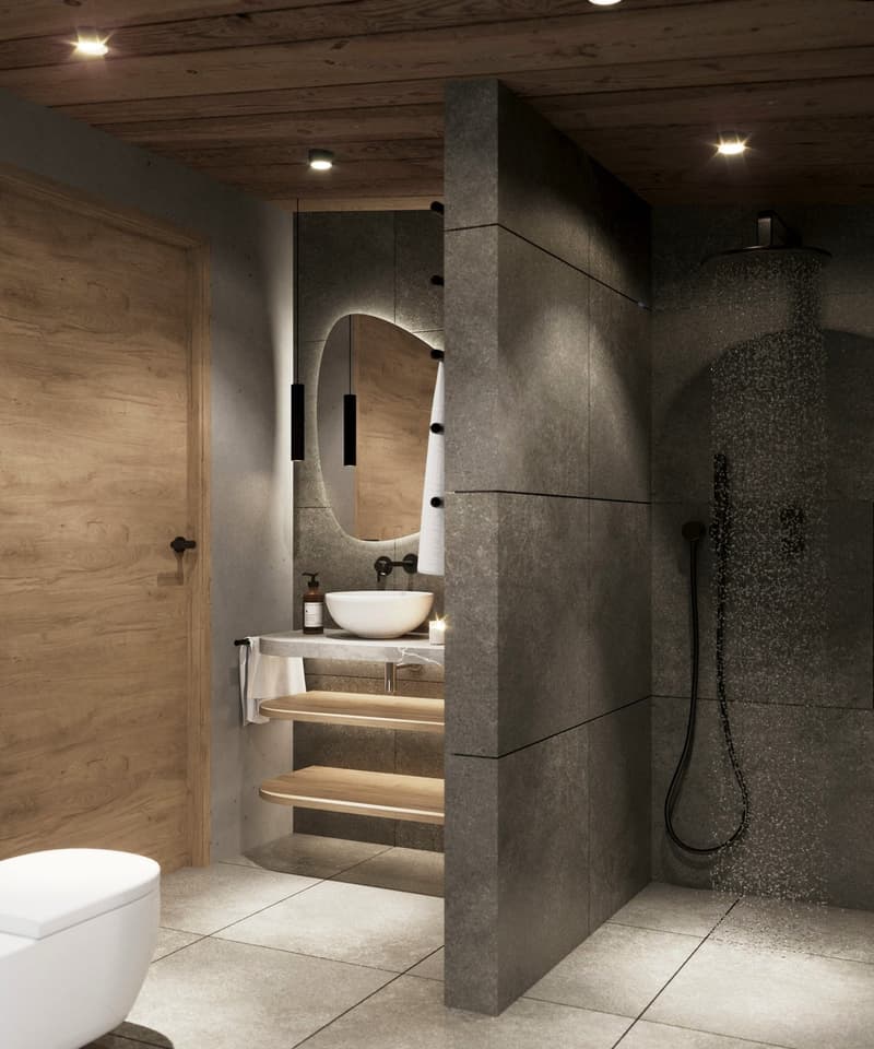 modern bathroom with grey tile floor, white toilet, white sink, round mirror, shower head, wooden shelves, wood paneling