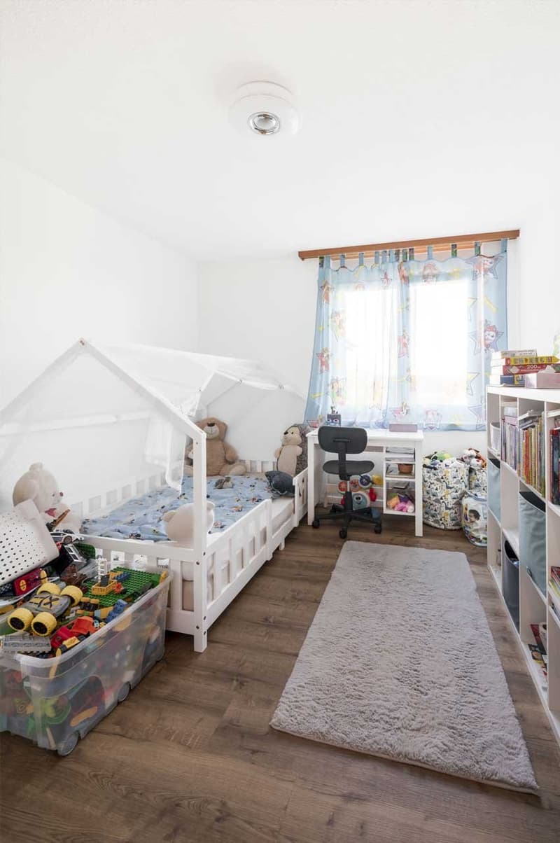 child's bedroom, white bed, toys, desk, shelves, rug