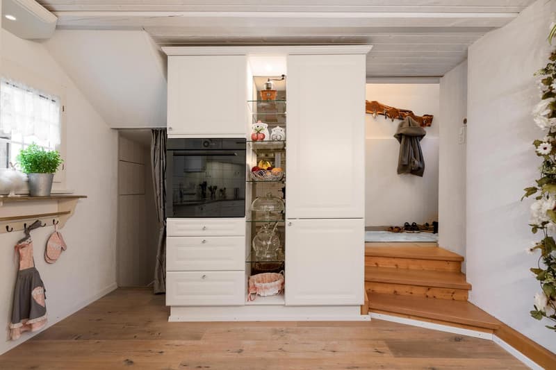 modern, white cabinetry, glass shelves, integrated oven, hardwood floor, white walls, window with potted plant
