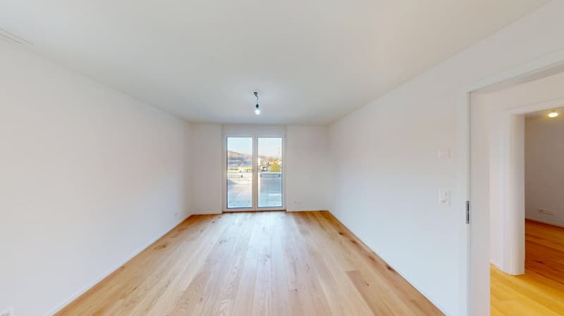 empty room, white walls, wooden floors, glass sliding doors with balcony
