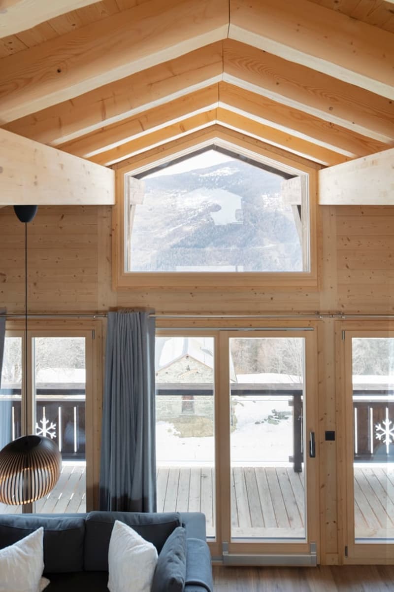 wooden ceiling, large windows, couch, pillows, lamp, wooden floor