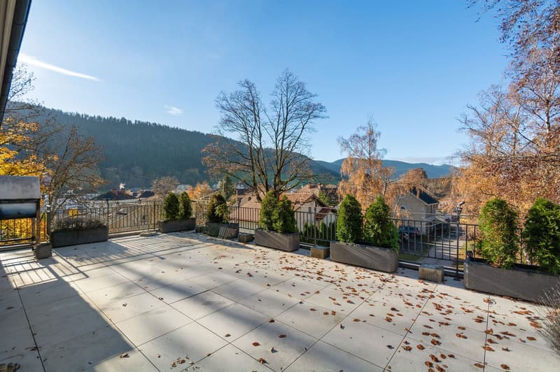 tiled floor, metal railing, fallen leaves, autumn trees, distant mountain