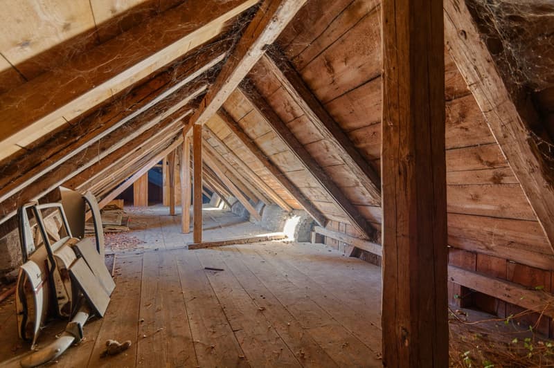 wooden beams, wooden flooring, spider webs, dusty, old car parts