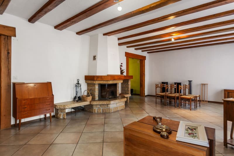 Fireplace, tiled floor, wooden ceiling, wooden furniture, dining table with chairs
