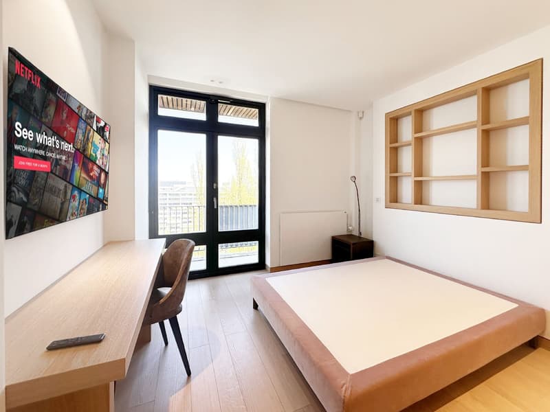 bedroom with bed, desk, chair, TV, balcony