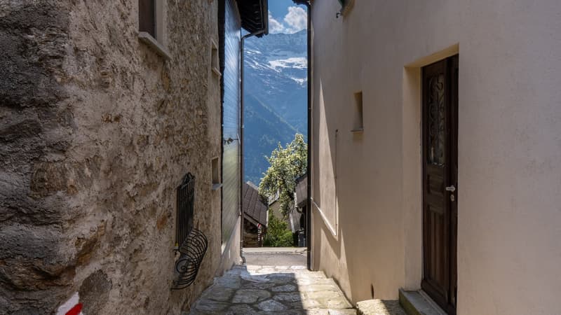stone wall, wooden door, stone path, mountain view