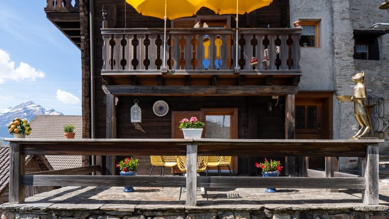 wooden house, balcony, terrace, yellow chairs, yellow umbrella, flowers, mountain view