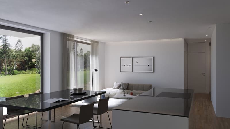 The image shows a modern, open-concept living and dining area with large windows overlooking a lush, green outdoor space. The living room features a gray sofa and minimalist artwork on the walls. The dining area has a black glass table with black chairs.