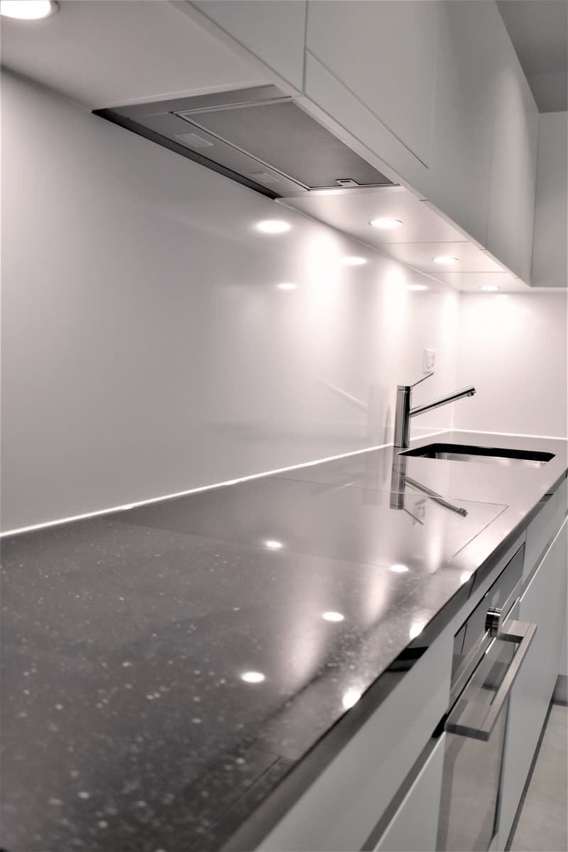 modern kitchen, granite countertops, stainless steel faucet, double sink, recessed lighting, built-in cabinetry, exhaust hood