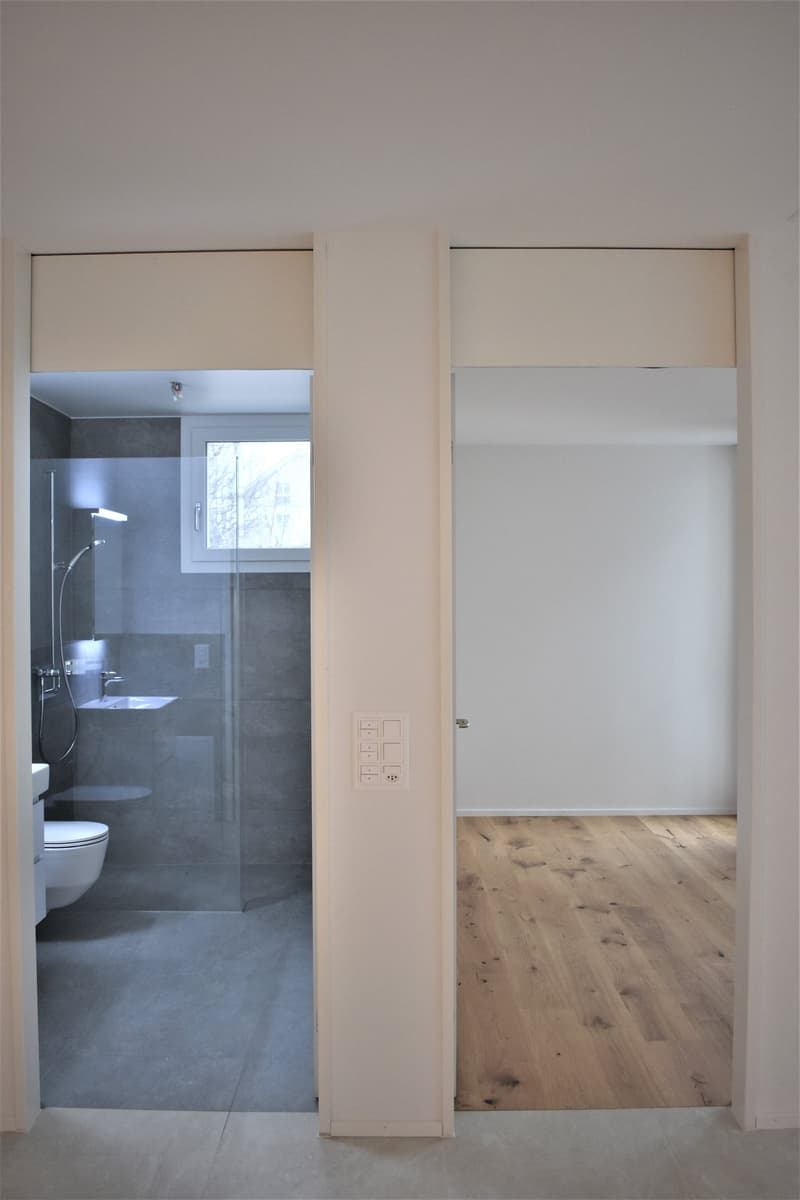 modern bathroom, glass door, shower, toilet, white tiles, sink