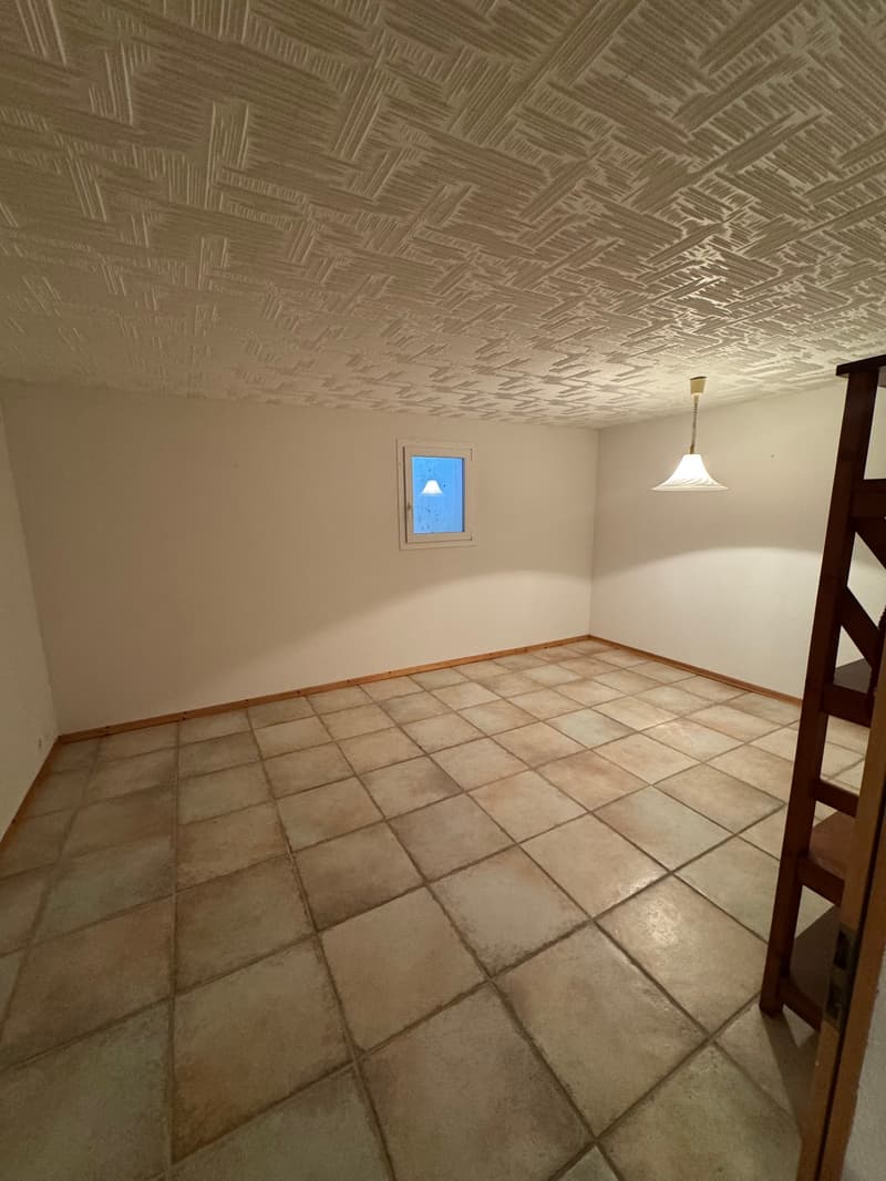 room with tiled flooring, white ceiling, white walls, window, hanging light fixture, ladder