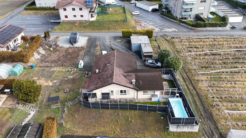 One story house, brown roof, pool, fenced yard, car parked