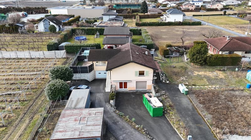 Aerial view of a modern house, two story, garage, outdoor pool, driveway