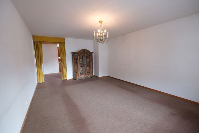 empty room, wooden cabinet, chandelier, carpet, yellow curtains