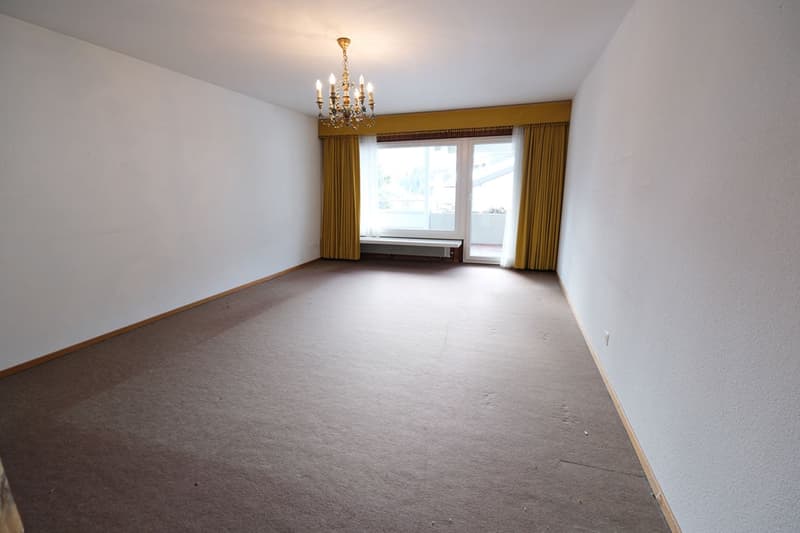 large empty room, chandelier, white walls, carpet, curtains, large window, door, bench
