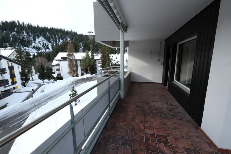 covered balcony, red brick tiles, metal railing, panoramic view of snowy mountains