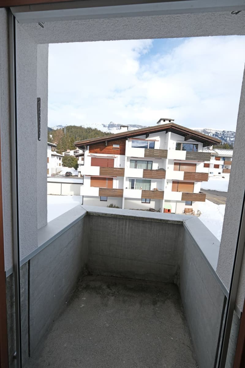 View of a balcony with a snowy mountain landscape.