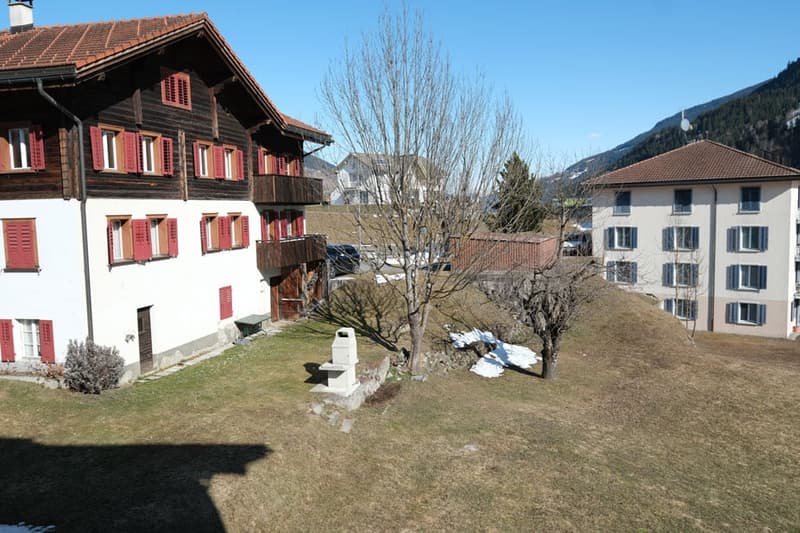 2 story house, wooden exterior, red shutters, mountain view
