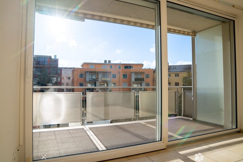 Glass doors leading to a balcony, city view