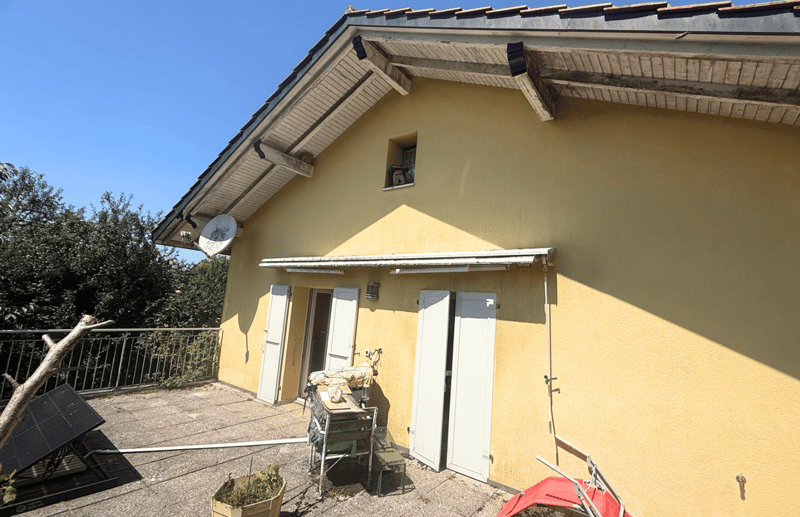 1-story house, yellow walls, white shutters, metal balcony, satellite dish