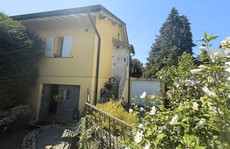 2 story house, yellow paint, white shutters, 2 doors, garage
