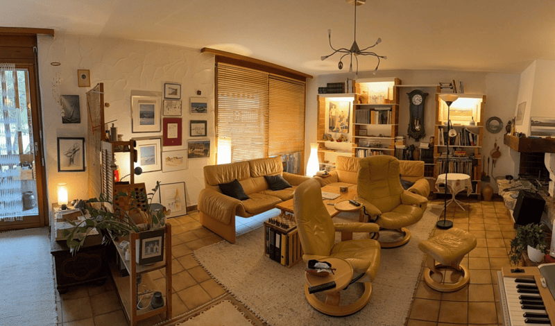 yellow chairs, coffee table, sofa, bookshelves, fireplace, clock, ceiling light, white floor