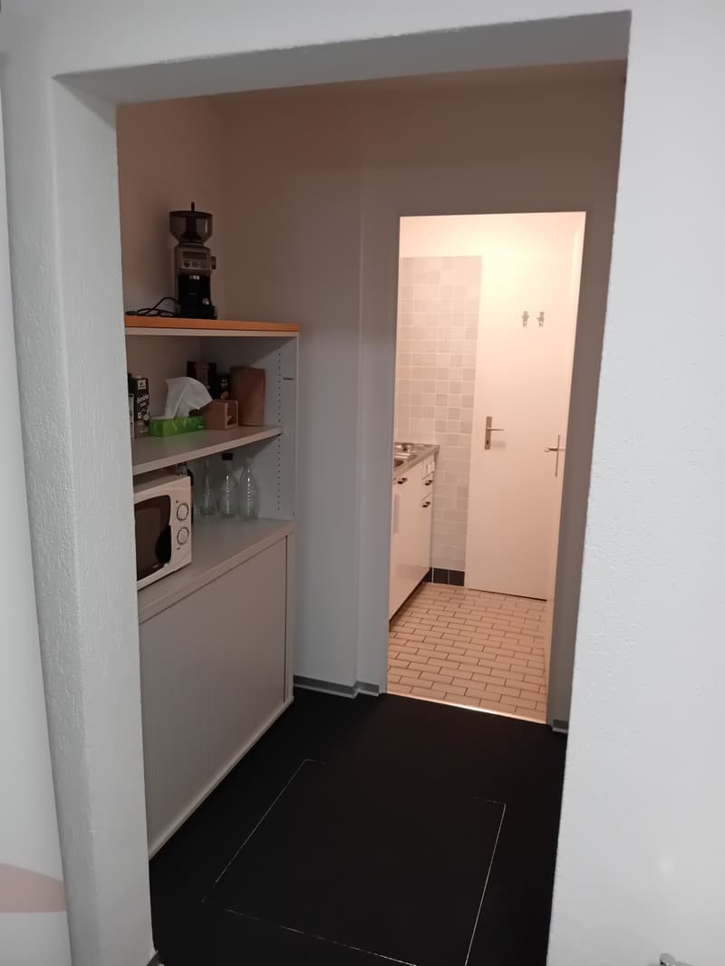 small kitchen with sink, cabinets, and a microwave