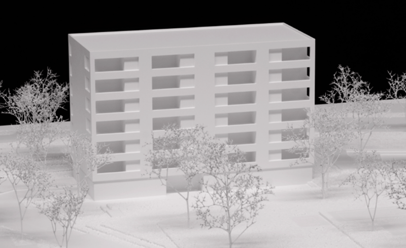 multi-story building, multiple rectangular windows, bare trees in front