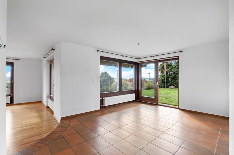 empty room with double sliding doors, wooden flooring, glass windows, white walls