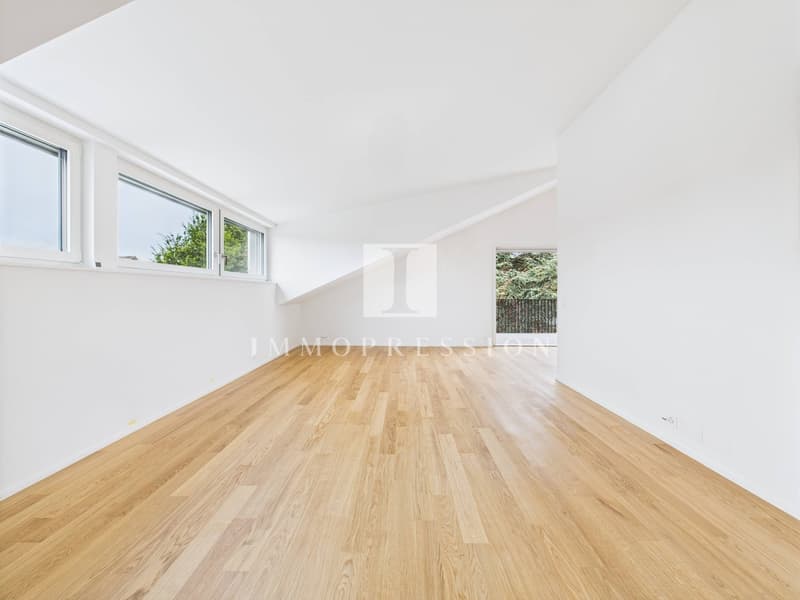 empty room, wooden floor, white walls, windows, slanted ceiling
