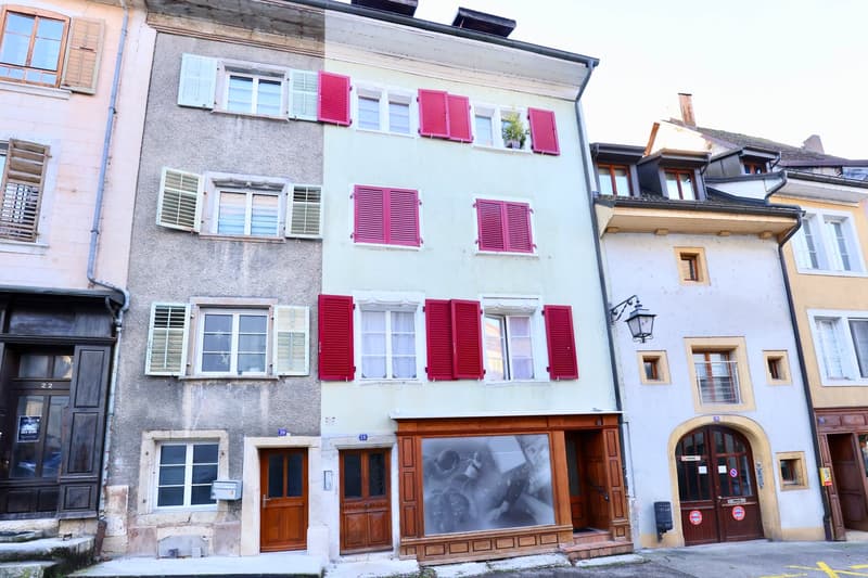 5-storey building, red shutters, arched doorway, mailboxes, street side