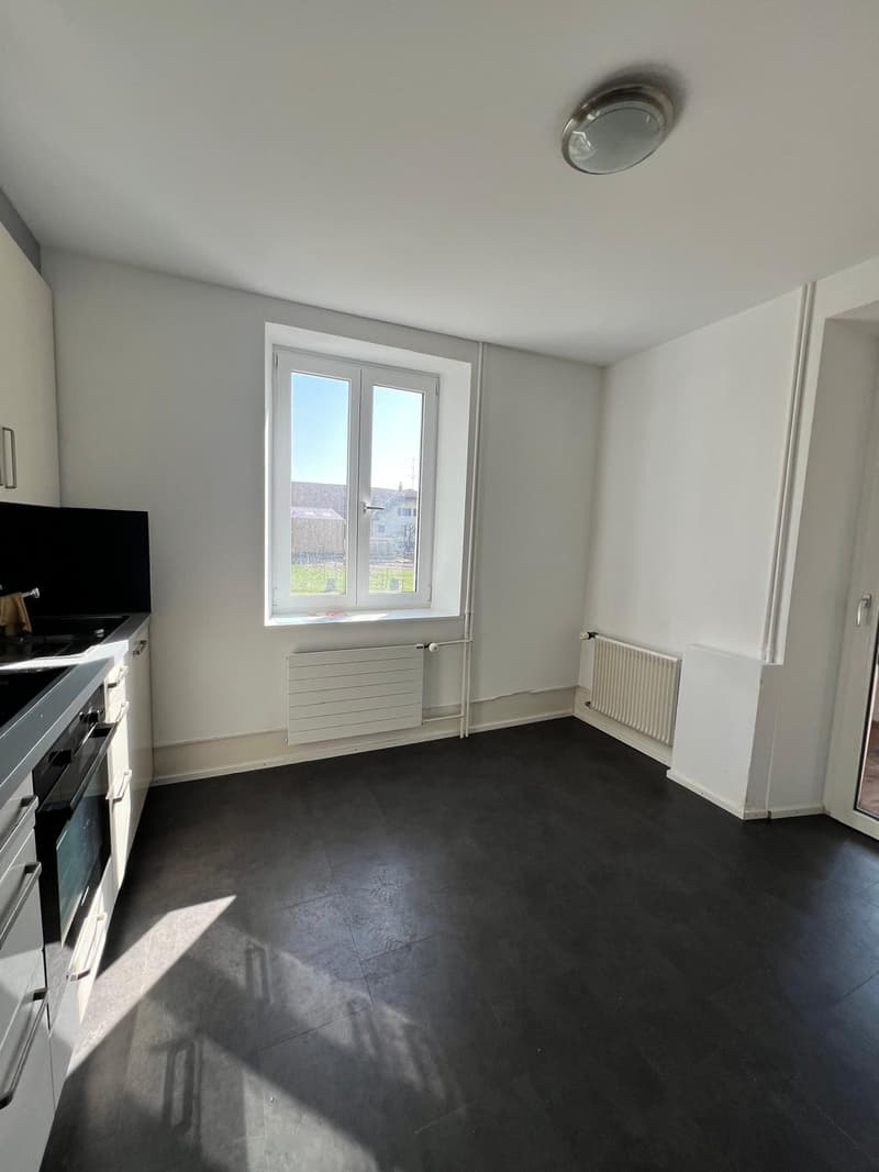empty kitchen, tile floor, white walls, sink, radiator, window