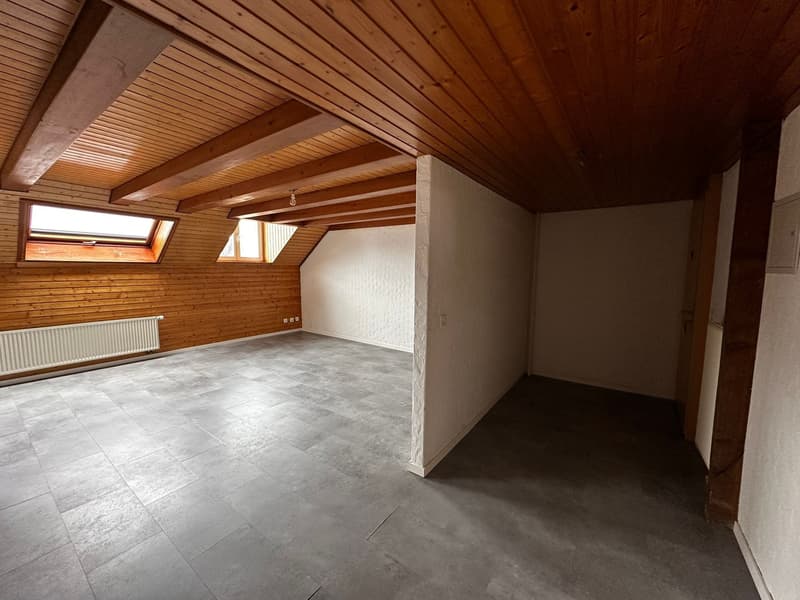 empty room, wooden ceiling, white walls, gray floor, wooden wall, window, radiator