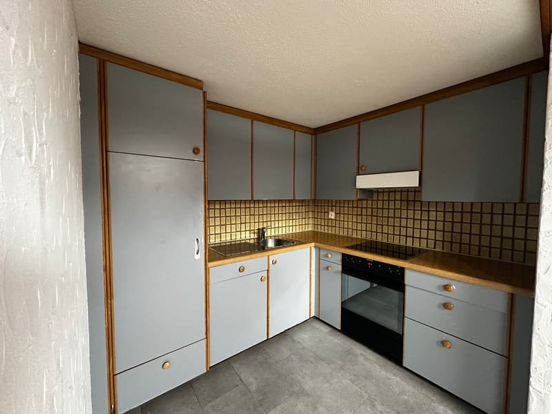 modern kitchen with wooden cabinets, tiled backsplash, stainless steel sink, black oven, dishwasher, and tiled floor