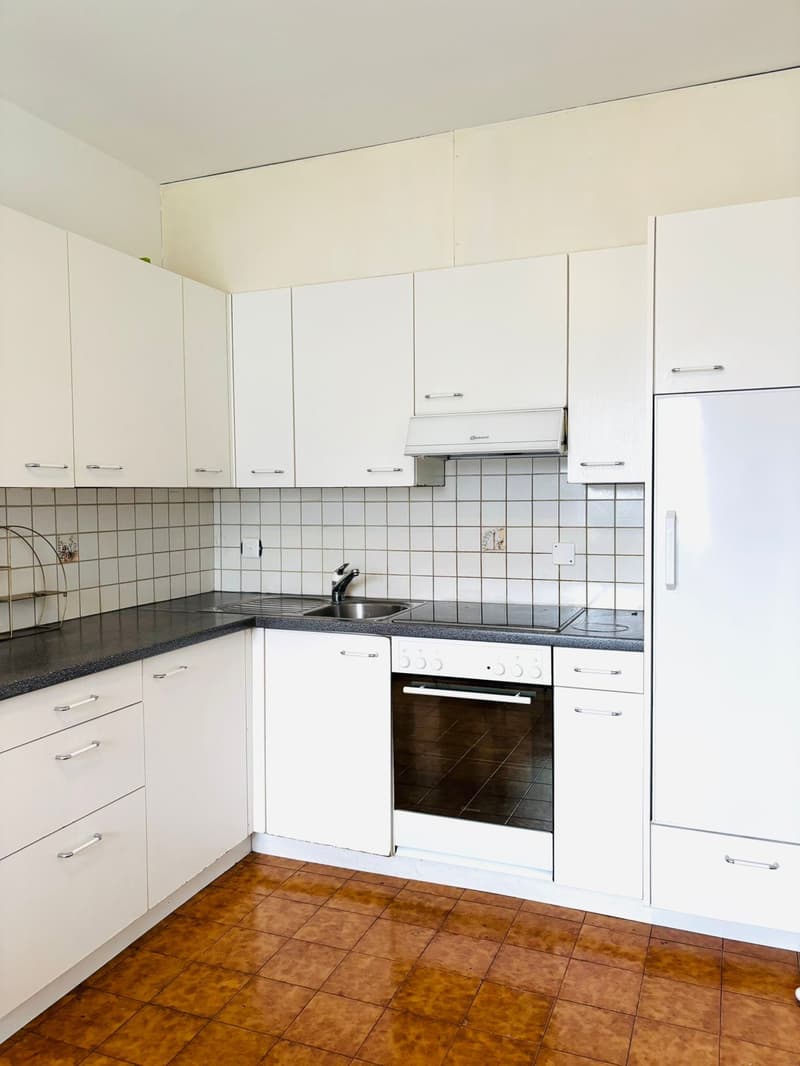 modern white kitchen, dishwasher, oven, sink, cabinets, tiled backsplash, tiled floor