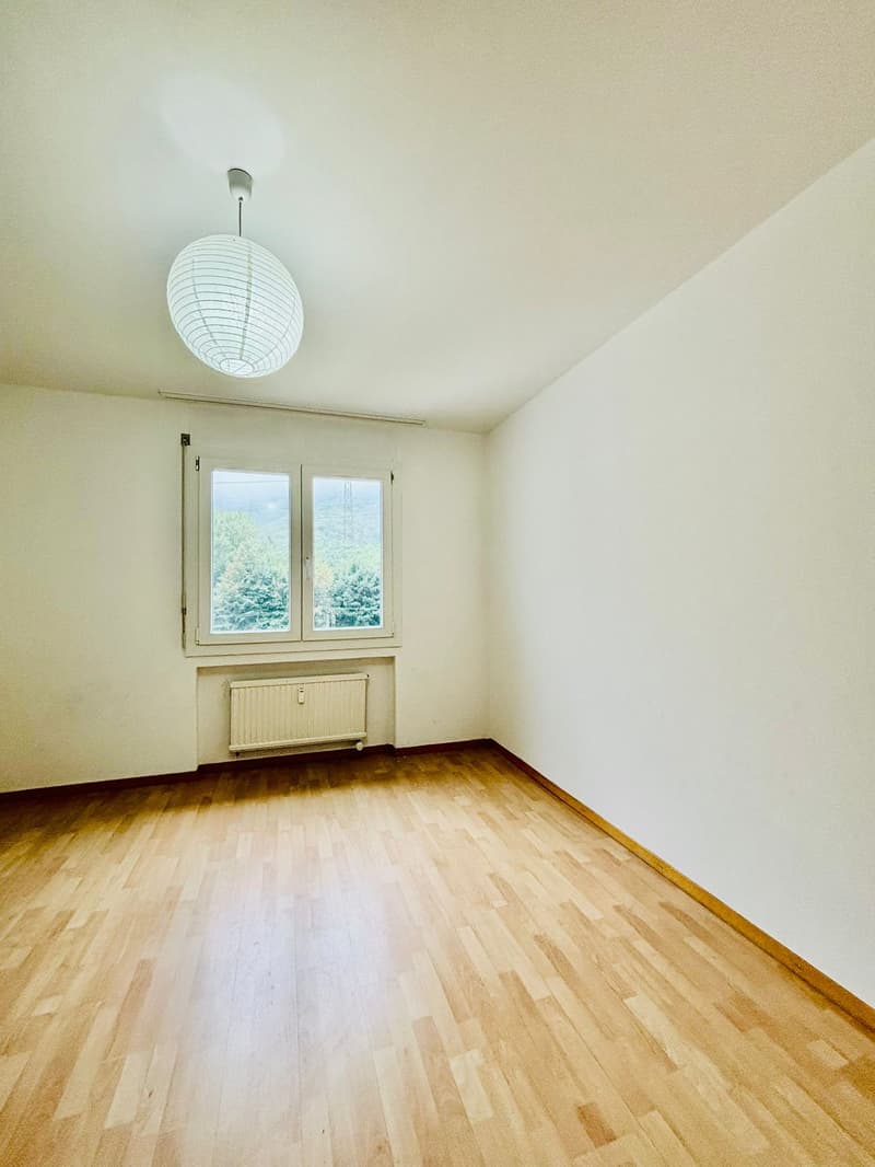 wood floor, large window, radiator, hanging lamp