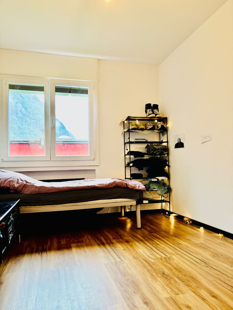 room with wooden floor, single bed, wardrobe, two windows, shoe shelf