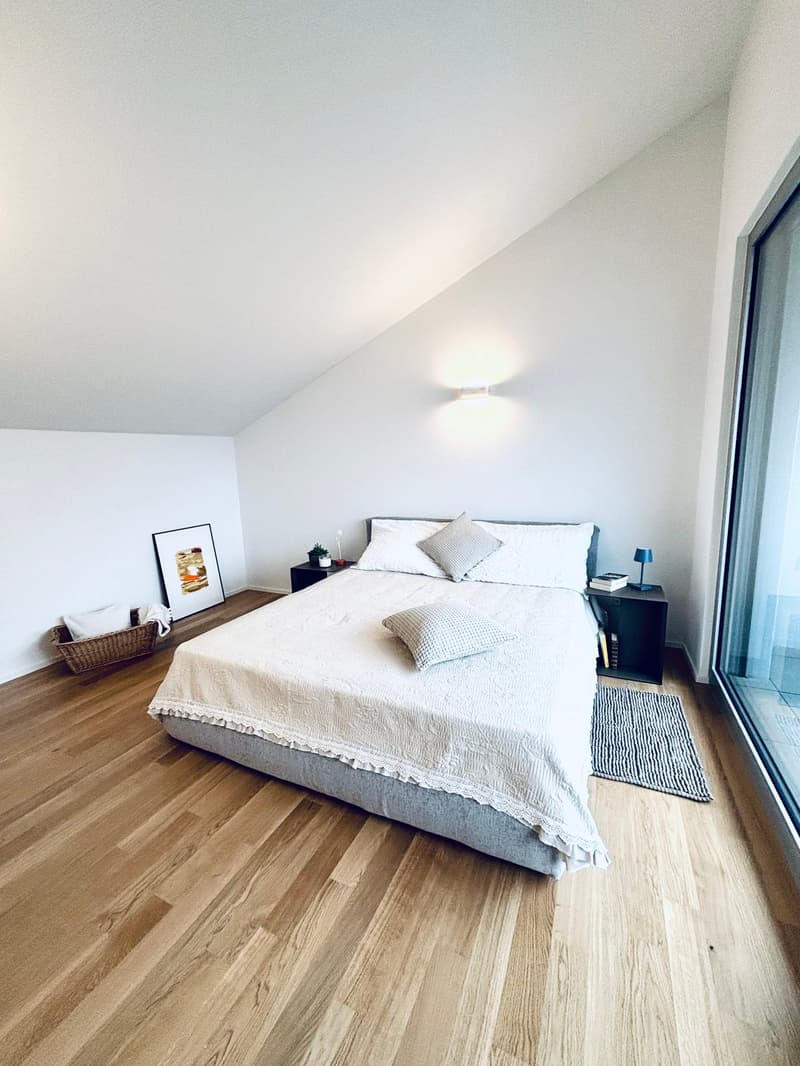 double bed with white bedsheet, two nightstands, framed art on wall, basket on floor, full length mirror