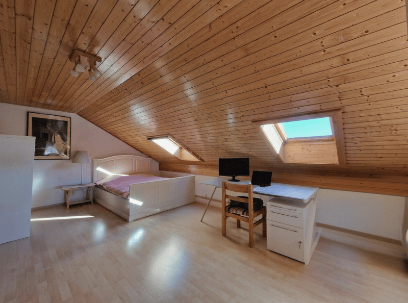 bedroom with bed, desk, chair, monitor, laptop, lamp, picture frame, wooden ceiling, wooden floor