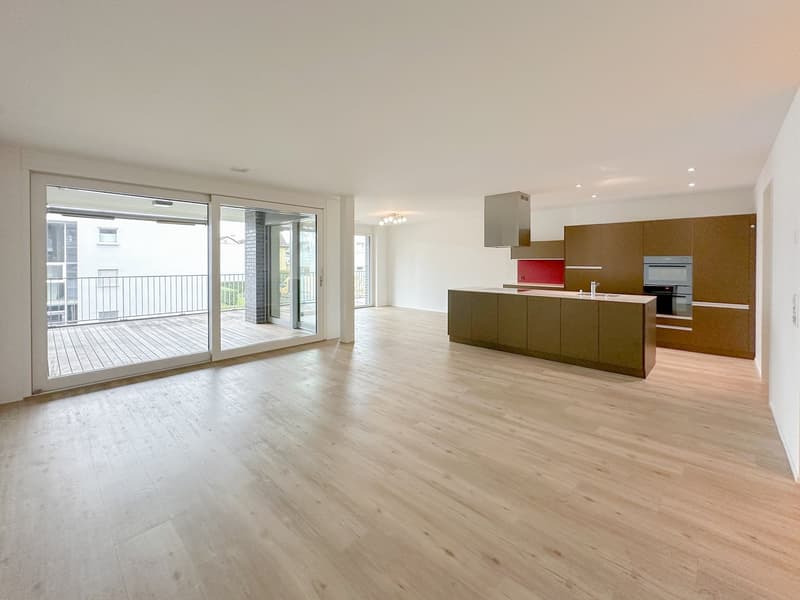 Open floor plan with balcony, modern kitchen with oven, sink, kitchen island, wooden floors
