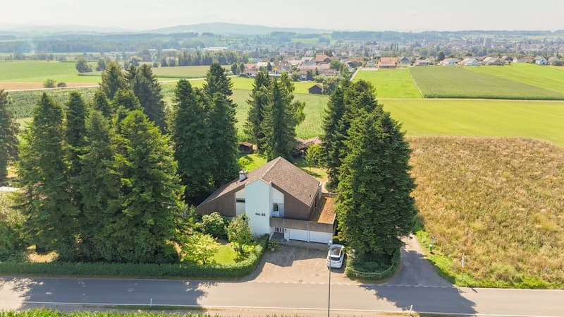 detached house, brown roof, white walls, attached garage, wide field view, surrounded by trees