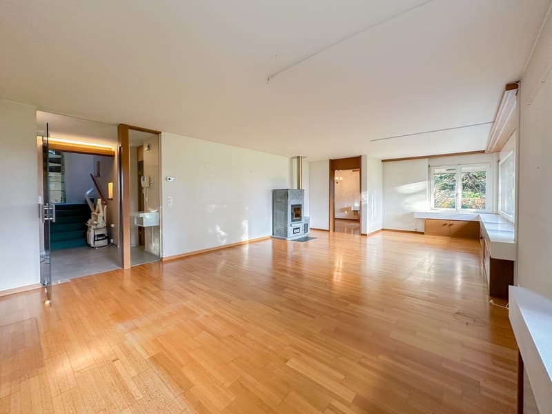 hardwood floors, white walls, fireplace, open to staircase