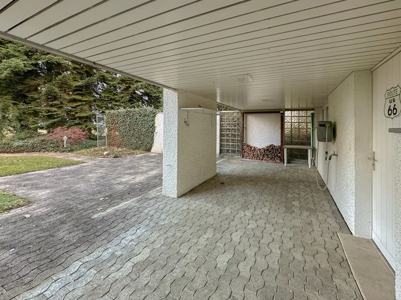 paved driveway, tiled floor, white ceiling with panels, shed, entrance with glass door