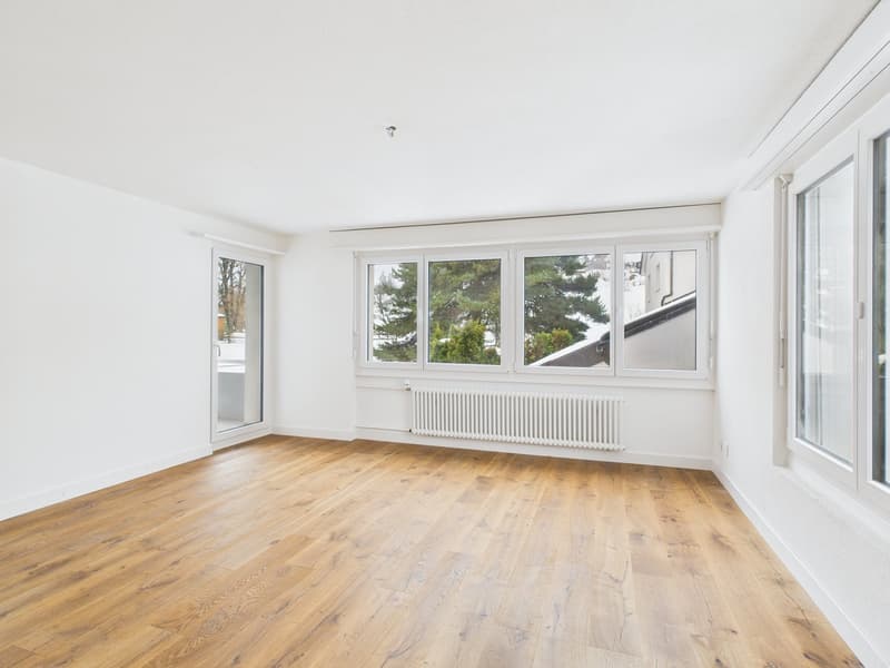 empty room, hardwood floors, white walls, 3 windows, sliding glass doors