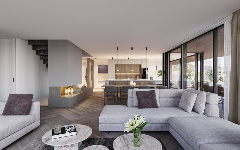 Spacious open-concept living room with large windows offering a scenic view, a modern fireplace, a gray sectional sofa, a marble coffee table, and a dining area with a wooden table and chairs adjacent to the kitchen.