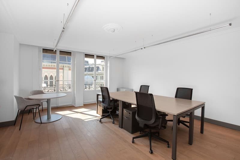 empty room, wooden floor, white walls, office table, 6 office chairs, glass windows, bright light