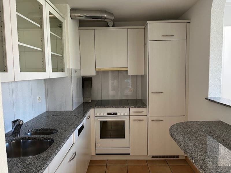 white kitchen with granite countertops, white cabinets, double sink, white oven, dishwasher