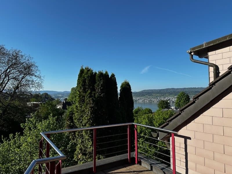 Modern balcony with railing, view of the town and lake